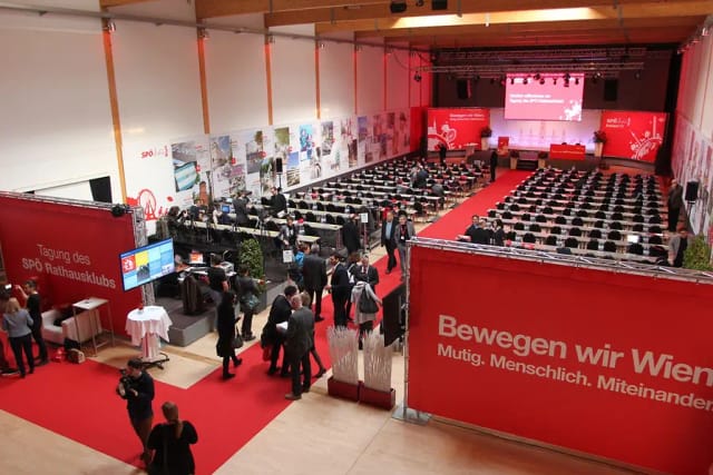 Spectacula plenary room with branded signage, classroom setup for corporate event and conference.