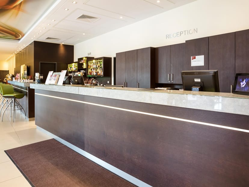 Modern hotel reception desk for corporate event registration and check-in services.