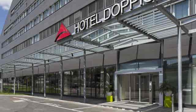 Modern Hotel Doppio facade with porte-cochère for corporate events and business meetings.