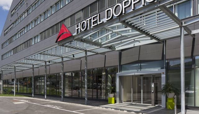 Modern Hotel Doppio facade with porte-cochère for corporate events and business meetings.