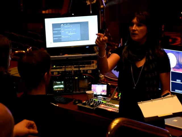 Production lead conducting tech briefing for event production at Encore Vienna.