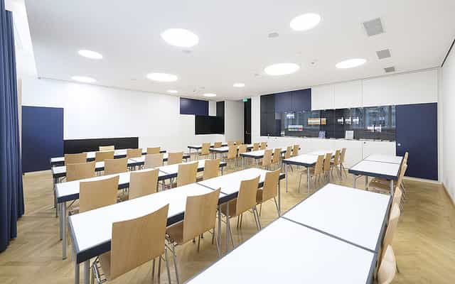 Modern UNIQA conference room set up for corporate training workshops and business seminars.