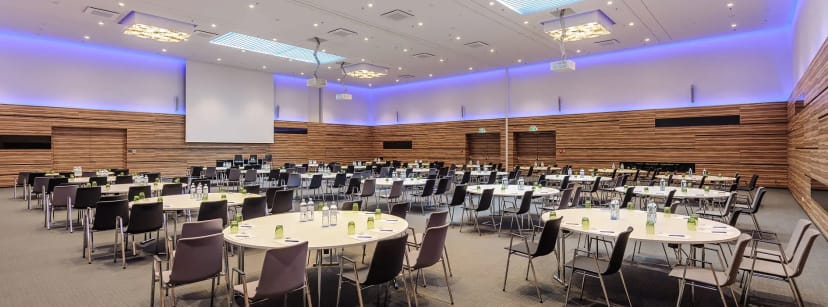 Meeting Room 5: Modern ballroom with wood-slat walls, ideal for plenary sessions and gala dinners.