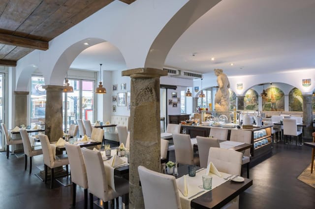 Upscale restaurant with architectural columns for corporate dinners and high-end board lunches.