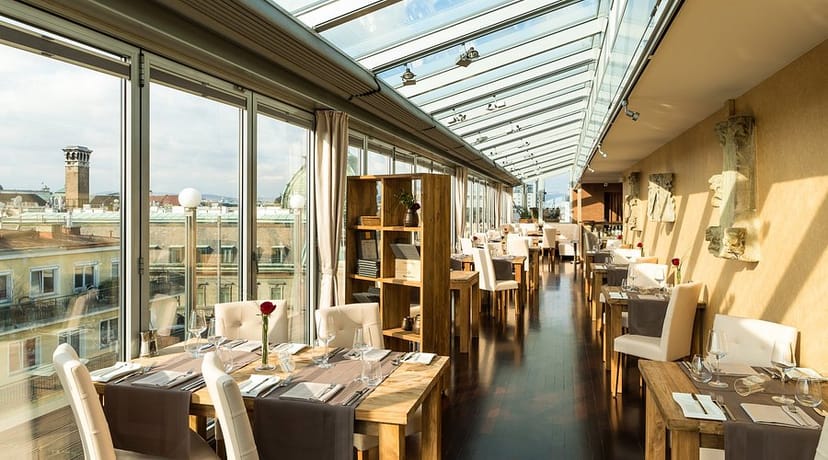 Luxury hotel private dining room with glass ceiling, ideal for corporate events and business lunches.