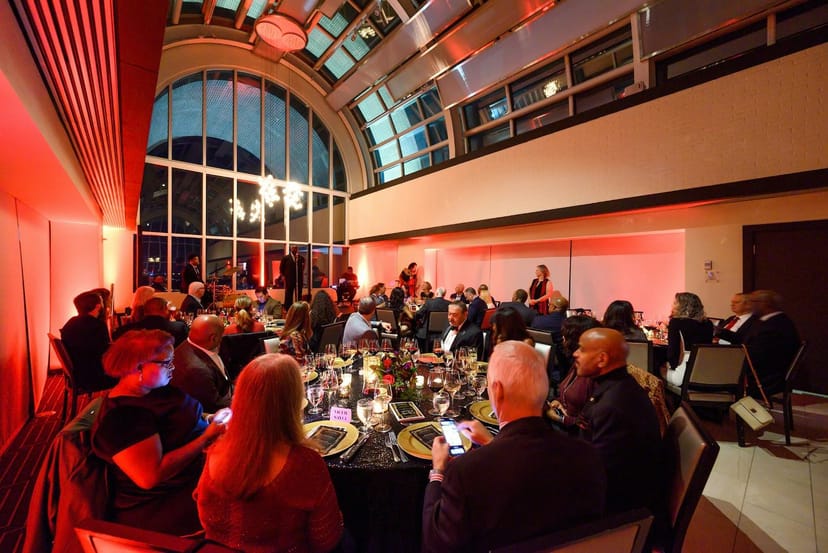 Tower Club Tysons gala meeting room with red uplighting for formal event and corporate dinner.