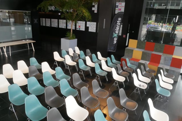 Modern weXelerate auditorium with theater seating for corporate events and conferences.