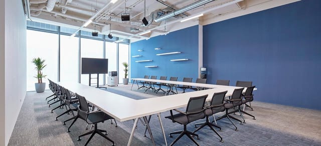 Modern U-shaped boardroom at weXelerate for corporate workshops and professional meetings.