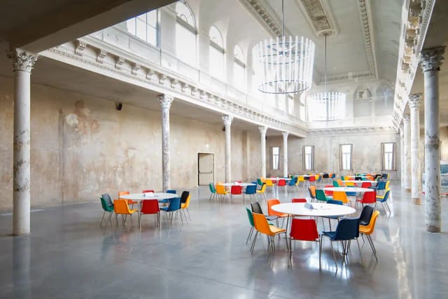Industrial event space at REAKTOR with high ceilings for weddings and corporate conferences.