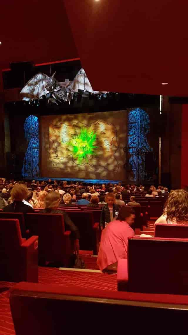 Stalls view of theatre projection mapping and theatrical lighting for corporate event staging.