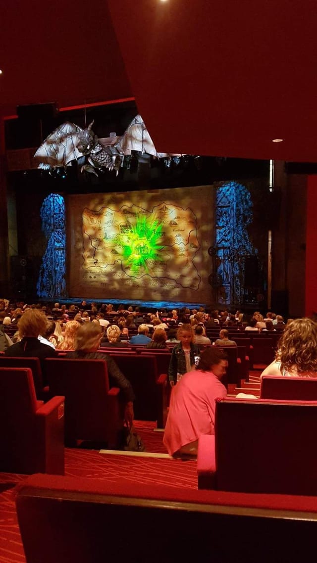 Stalls view of theatre projection mapping and theatrical lighting for corporate event staging.