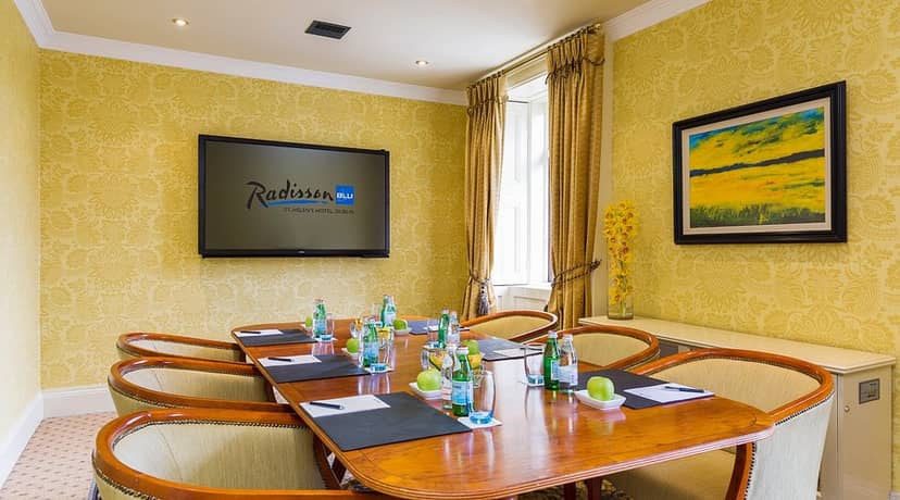 Boardroom at Radisson Blu St. Helen's Dublin with wood table for executive business meetings.
