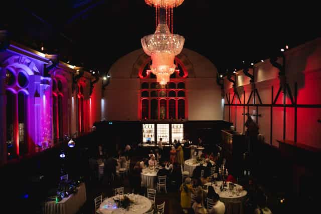 Thomas Prior Hall gala venue with dramatic uplighting and chandelier for upscale event celebrations.