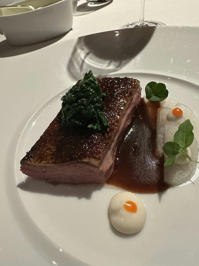 Seared protein entrée in Restaurant Patrick Guilbaud private dining room for gala corporate catering.