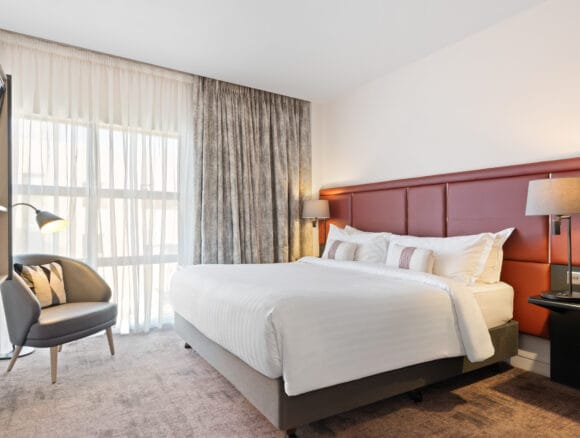 Modern penthouse hotel room with task lighting for corporate events and business room blocks.