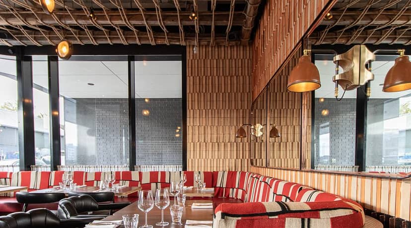 Private dining room with plush banquette seating for high-end networking and corporate events.