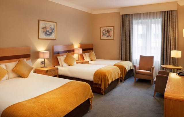 Triple-occupancy meeting room at Green Isle Hotel for group event lodging and conference stays.