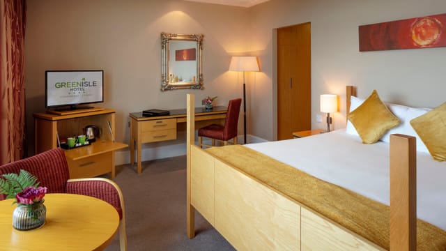 Green Isle Hotel room with workspace for corporate business travel and conference meetings.