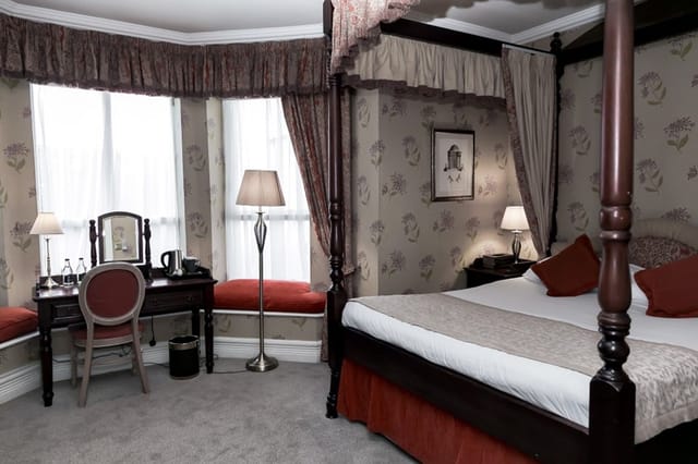 Luxury guest room at Butlers Townhouse with workspace for executive conference speakers.
