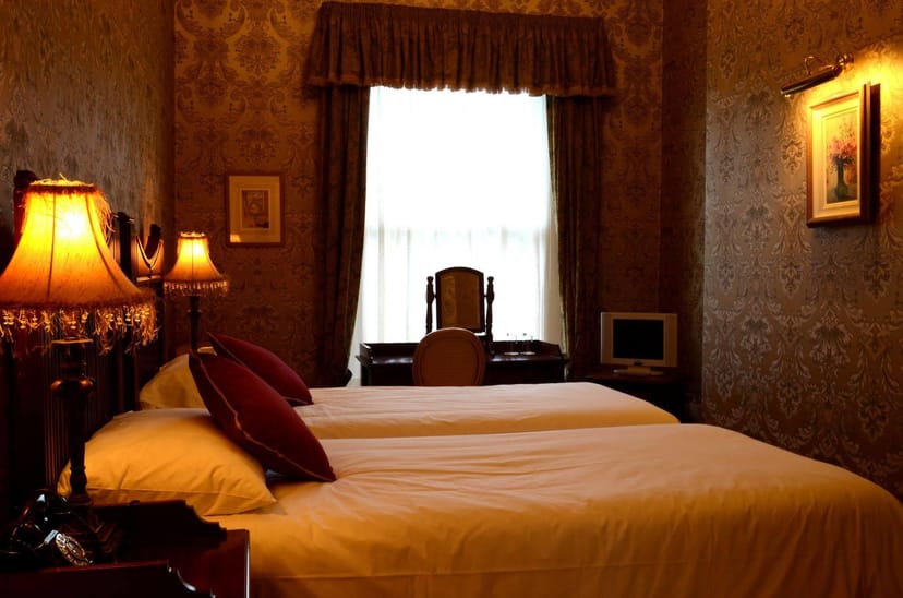 Historic twin hotel room at Butlers Townhouse for budget group travel and vintage stays.