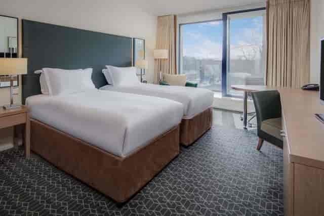 Modern Hilton Dublin Kilmainham twin guest room with workspace for business conferences.