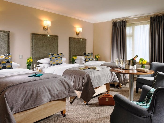 Triple-occupancy hotel room with modern amenities for event accommodation and business travel.