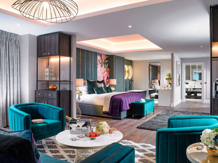 Luxury hotel suite with floral teal decor for VIP corporate events or bridal preparations.