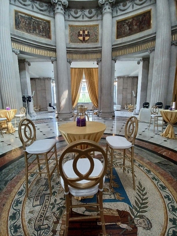 Neoclassical City Hall rotunda with marble columns, set for a luxury cocktail reception and gala.
