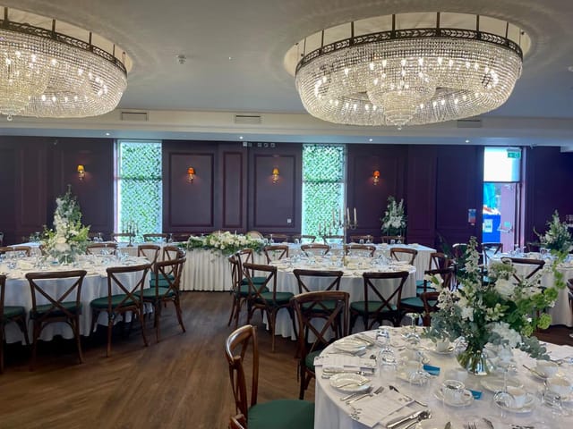 Grand ballroom at The Abbey with crystal chandeliers, ideal for luxury weddings and corporate galas.