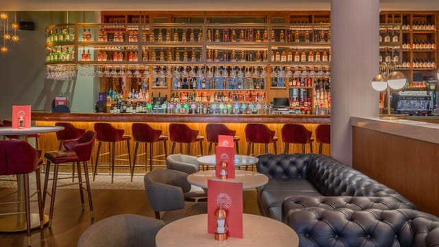 Modern hotel lounge bar with banquette seating for professional networking and corporate events.