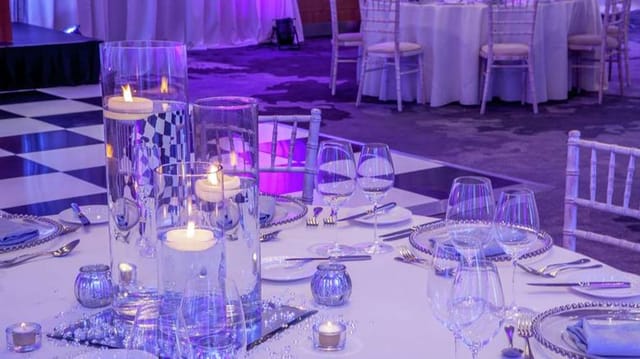 Conrad Dublin gala meeting room with purple lighting, elegant centerpieces, and Chiavari chairs.