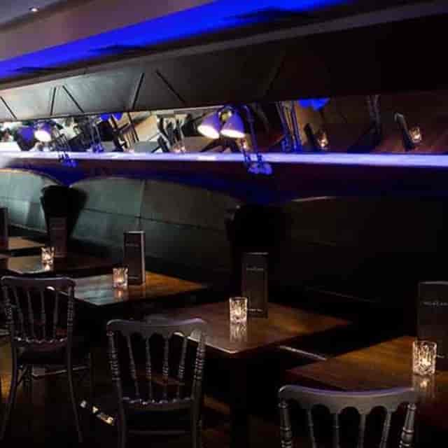 Moody Morgan Hotel bar with booth seating for intimate VIP networking and corporate event spaces.
