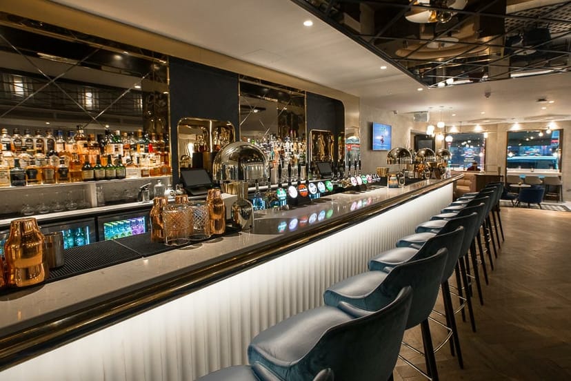 Modern hotel bar at The Morgan Hotel with high-top seating for networking and corporate events.