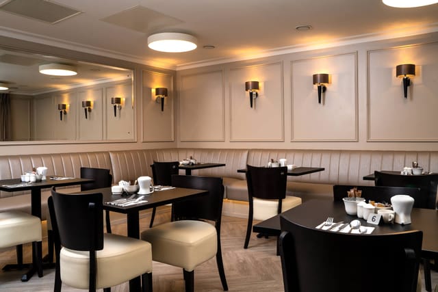 Formal dining room with banquette seating, ideal for corporate events and private catering.