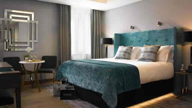 Luxury Dylan Hotel Room 1900 with teal headboard for VIP executive travel and incentive meetings.