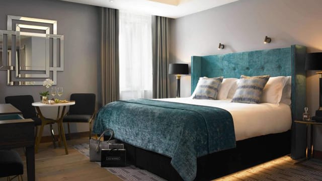 Luxury Dylan Hotel Room 1900 with teal headboard for VIP executive travel and incentive meetings.