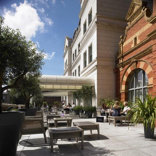 Sun-drenched terrace at The Nurserie, Dylan Hotel, for corporate networking and event hosting.