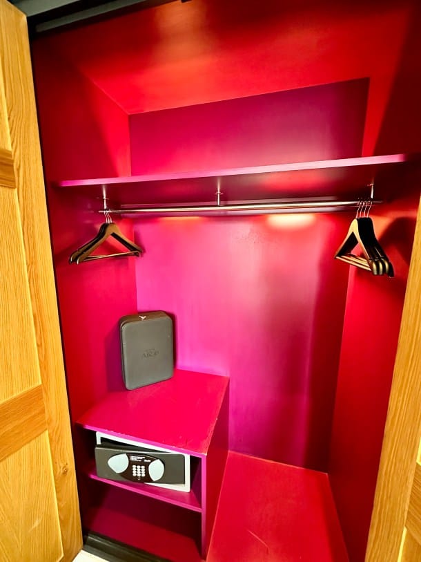 Sparse hotel closet at The Curious Mister; professional travel accommodation decor.