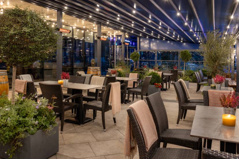 Outdoor event space with retractable roof for intimate wedding receptions and corporate parties.
