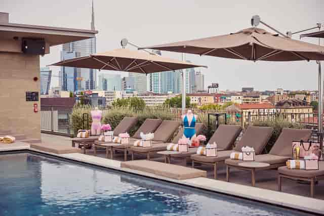 The VIU Terrace rooftop event setup with branded decor and Milan skyline view for luxury launches.