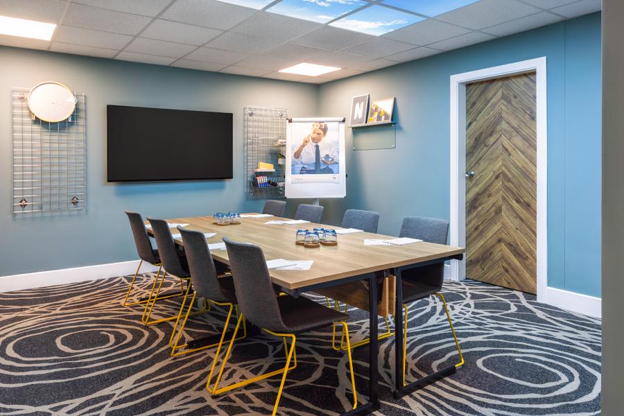 Novotel Edinburgh Centre breakout room with patterned carpet for collaborative workshops and meetings.