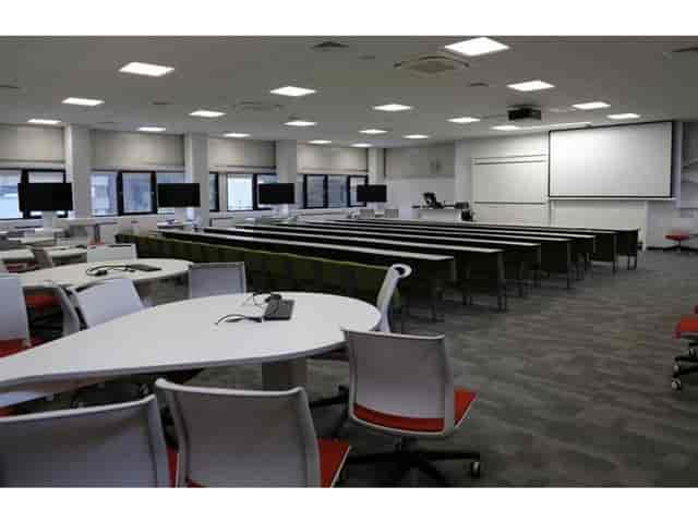 Cairn Auditorium with tiered seating and round tables for corporate meetings and conferences.