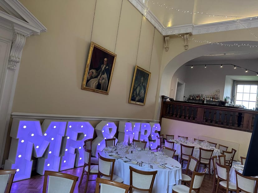 Farnham Castle Great Hall wedding venue with marquee lighting for modern heritage receptions.