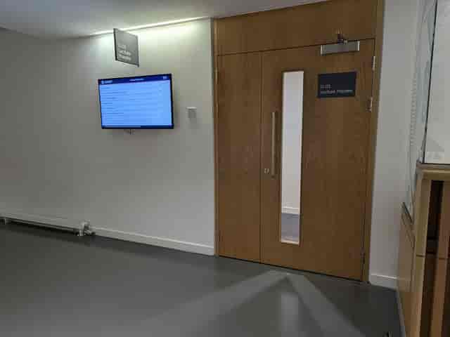 Lecture Theatre G.03 entrance with digital wayfinding for academic events and conference bookings.
