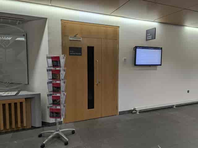 Lecture Theatre G.03 entrance with digital display for corporate meetings and event hire.