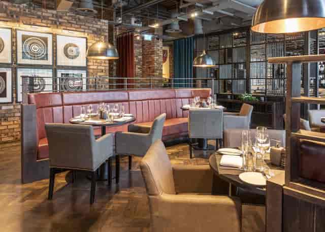 Upscale Dakota Bar in Edinburgh with industrial decor, perfect for networking events and meetings.