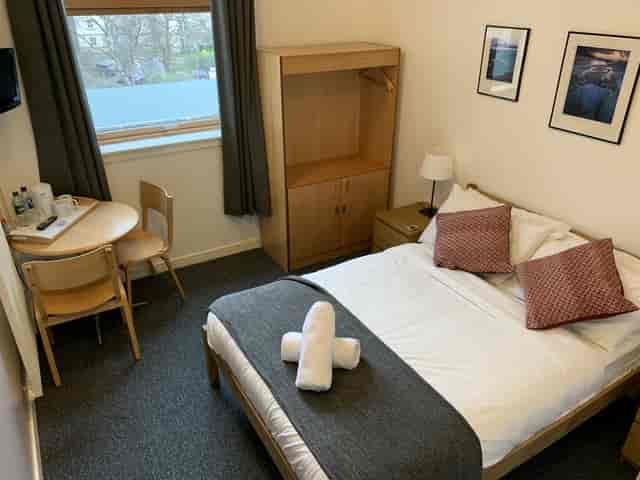 Compact private guest room in Edinburgh for budget corporate travel and event accommodation.