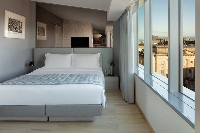 Modern Radisson Edinburgh conference room with floor-to-ceiling windows for executive events. - Banner