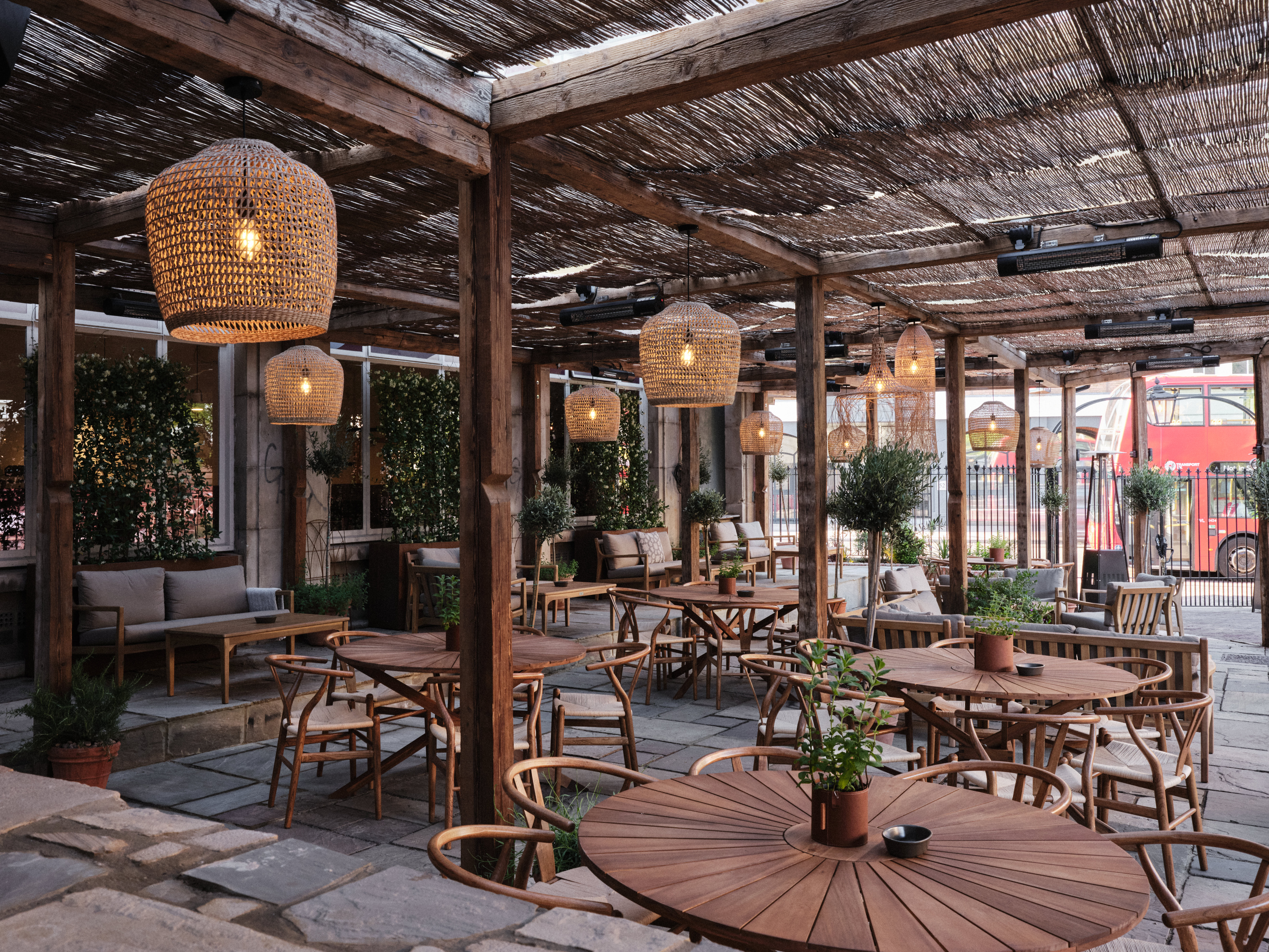 Stylish outdoor event space with cozy furniture, ideal for gatherings and networking. - Banner