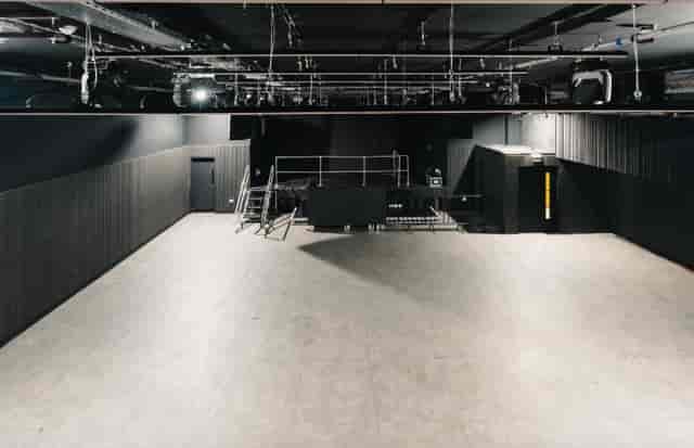 Versatile event space with a high ceiling for conferences and performances at Ambers Club.